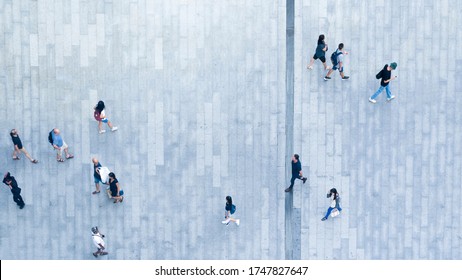 Human Life In Social Distance. Top View Of Motion Blur People Are Walking In Public Space On Concrete Pavement Landscape. Concept In Aerial View Of Man And Woman Family With Empty Space.