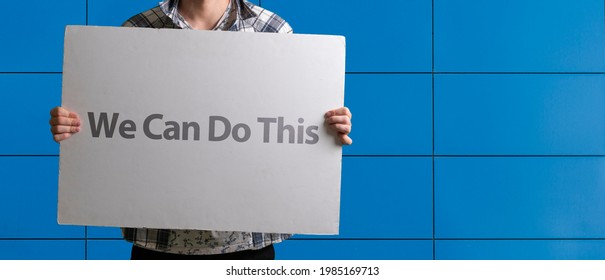 Human In Mask Holding A White Frame Banner With Text 