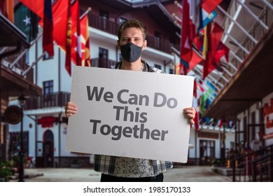 Human In Mask Holding A White Frame Banner With Text 