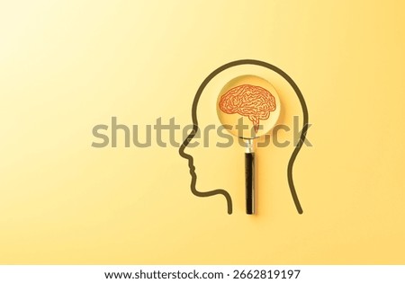 Human Mind Analysis and Intelligence Research Concept. Magnifying glass focuses red brain inside human head outline representing mental health assessment, memory, cognition, and psychological analysis