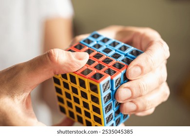 Human mind and hands are solving alternative Rubik's puzzle cube