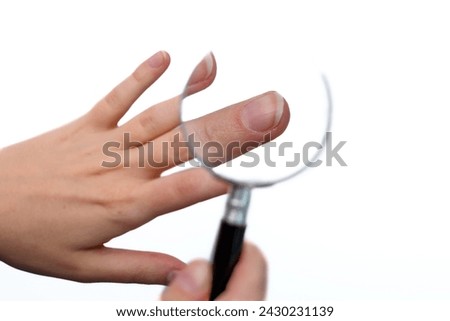 Human nail close up under a magnifying glass
