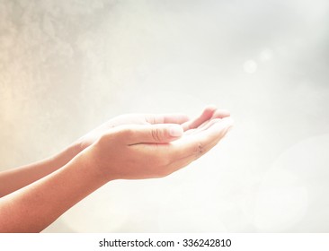 Human Open Two Empty Hand With Palms Up Over Blurred Makkah Background.