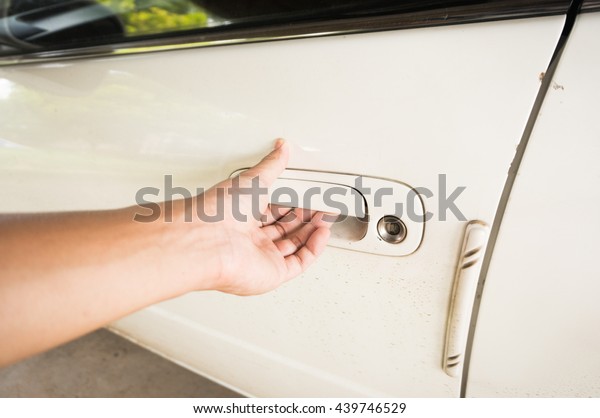 Human opening car door with
Hand