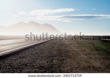human person walks towards the light of the fog on the road. westerly wind at cabo de gata