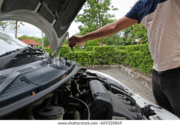 Human\
preparing the car before departure for\
safety