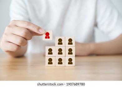 Human resource management and recruitment business concept. Hand holding wooden cube block with human icon symbol