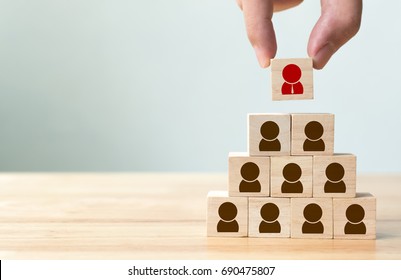 Human resource management and recruitment business concept, Hand putting wood cube block on top pyramid, Copy space - Shutterstock ID 690475807