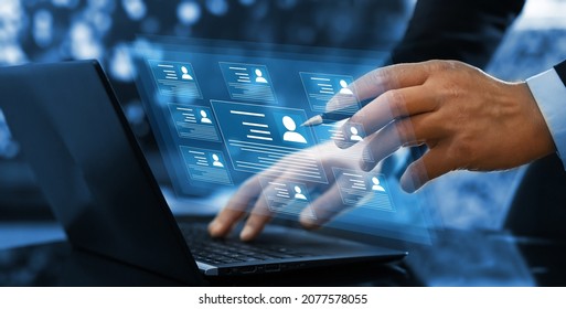 Human resource manager checks the CV online to choose the perfect employee for his business. Online and modern technologies for simplifying the human resources system.HR(human resources) technology. - Shutterstock ID 2077578055