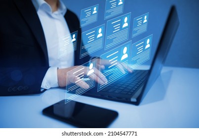 Human resource manager checks the CV online to choose the perfect employee for his business. HR(human resources) technology.Online and modern technologies for simplifying the human resources system. - Shutterstock ID 2104547771