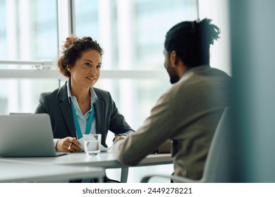 Human resource manager communicating with African American candidate during job interview in the office. Copy space. 