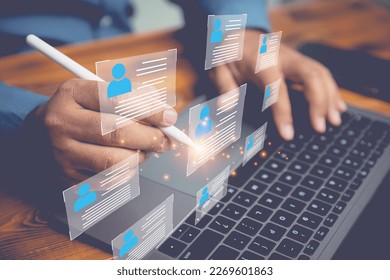 The human resource manager is recruiting employees. Checks the CV online to choose the perfect employee for his business. The human resources system is digital and online. - Shutterstock ID 2269601863