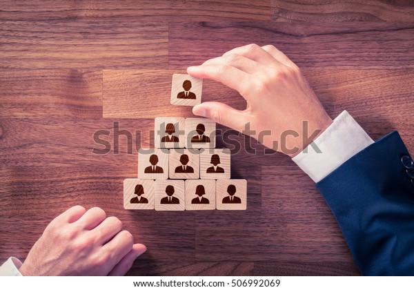 Human\
resources and corporate hierarchy concept - recruiter complete team\
by one leader person (CEO) represented by\
icon.