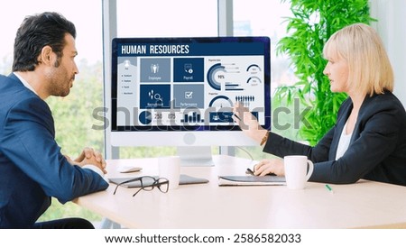 Human resources management software on computer screen helping human resources employee to manage recruitment, payroll, staff searching and KPI evaluation snugly