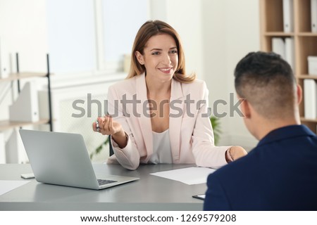 Human resources manager conducting job interview with applicant in office