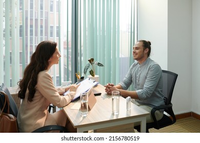 Human resources manager holding cv of candidate when explaining his career opportunities - Shutterstock ID 2156780519