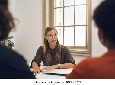 Human Resources Manager Meeting With Colleagues, Settling A Dispute Or Argument In Her Office. Serious Female Leader Talking, Meeting And Planning With Her Team And Staff Members At Work