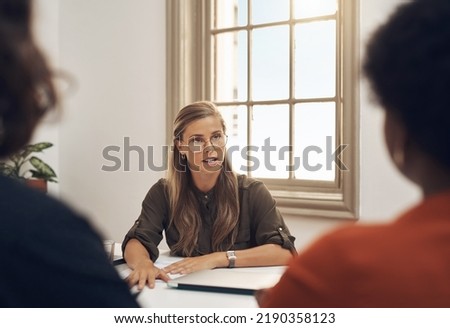 Human resources manager meeting with colleagues, settling a dispute or argument in her office. Serious female leader talking, meeting and planning with her team and staff members at work