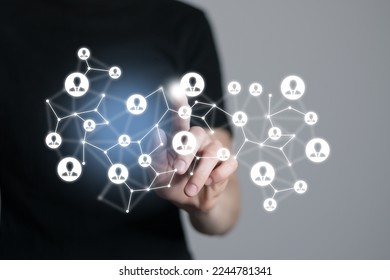 Human resources manager pointing at virtual network chain with person icons. Human capital and teambuilding concept. - Shutterstock ID 2244781341