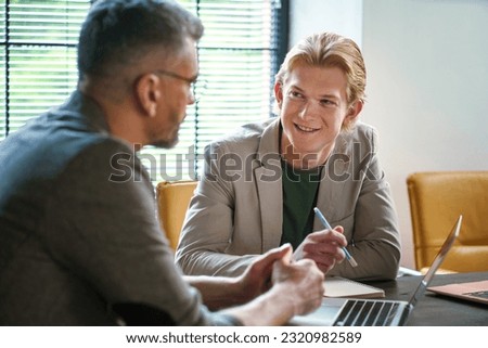 Human resources, specifically hiring process. Manager conducting job interview with worker in office. Professional atmosphere of interview, showcasing interaction between hiring manager and candidate