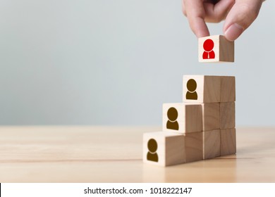 Human resources and talent management and recruitment business concept, Hand putting wood cube block on top staircase, Copy space - Shutterstock ID 1018222147