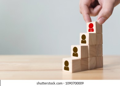 Human resources and talent management and recruitment business concept, Hand putting wood cube block on top staircase, Copy space - Shutterstock ID 1090700009