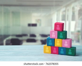 Human Resourses And Recruitment Concept. Wooden Blocks Pyramid On Wooden Table