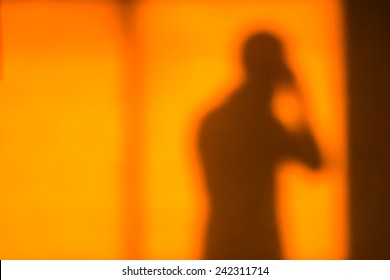 Human Shadow On Wall In Sunset Light Amber Color Back Ground