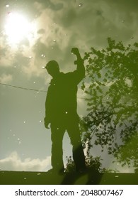 human shadow reflected in the water