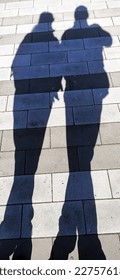 Human shadows on the tile road