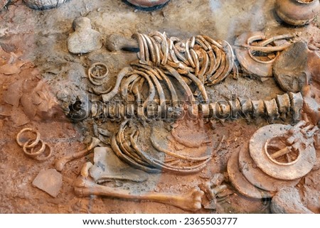 Human skeleton with ancient jewelry or clothing and food containers at the Ban Non civilization site, a temple that is more than 4,000 years old, Non Sung, Nakhon Ratchasima Thailand.
