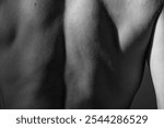 Human skin texture, detail healthy male skin. Male back muscles close up, black and white