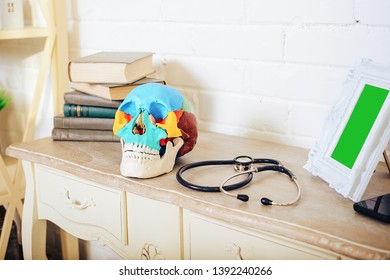 A Human Skull With Books And A Stethoscope On The Shelf.