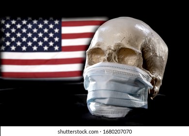 A Human Skull In A Medical Mask On The Background Of The American Flag . Concept: The Death Rate In America From A Coronavirus, A Global Pandemic, Infection With The Deadly Virus.