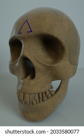 Human skull with an symbol on the forehead. - Shutterstock ID 2033580077