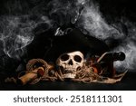 Human skull with toy model of cannon, pirate hat, world map and scroll on black background