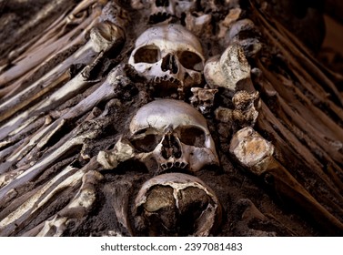 Human skulls with bones on the sides creating a macabre design of The Chapel of Bones located in the city of Évora in Portugal. Built in the 17th century at the initiative of three Franciscan monks.