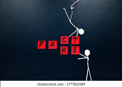 Human Stick Figure Changing Word Fact To Fake. Dark Background. Facts Versus False News Concept.