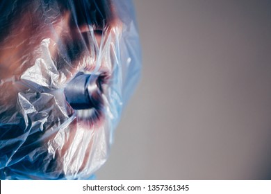 Human suffocating in plastic bag. Plastic pollution problem themed image. STOP using plastic! 