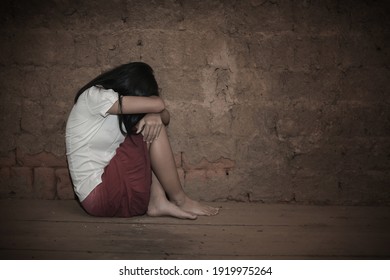 Human Trafficking Concept, Sad Girl Sitting Alone In An Old Empty Room.