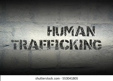 human trafficking stencil print on the grunge white brick wall - Shutterstock ID 553041805