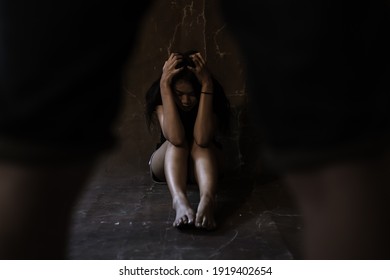 Human trafficking and Violence concept Abduct guy threaten asian woman and going to hit her Young girl get shocked and crying Girl is always victim of violence She get hopeless She get scared - Shutterstock ID 1919402654