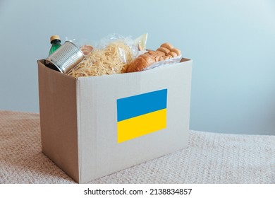 Humanitarian help to refugees and needy people from Ukraine. The box contains basic necessities and food: pasta, bread, canned food, water, cookies.