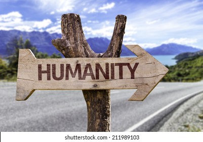 Humanity wooden sign with a street background 