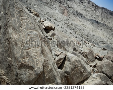 humanoid figure carved in the rock, primitive petroglyphs of Huancor, Peru	
