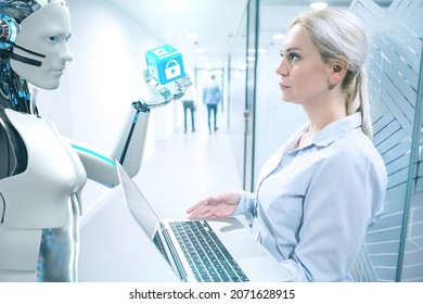 A humanoid robot explains the company's IT security to the businesswoman. 