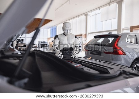 A humanoid robot inspecting the engine of a car in a modern showroom environment