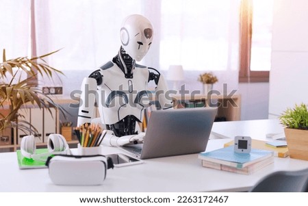 A humanoid robot works in an office on a laptop, showcasing the utility of automation in repetitive and tedious tasks.