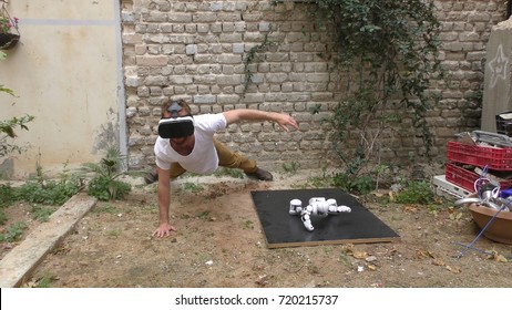 A humanoid robot and a young man exercise push ups because they want to be fit. The man sees the robot via head mounted display. The robot has a lot of patience and it repeats the movements precisely. - Powered by Shutterstock