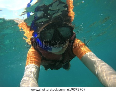 Humans dive under the sea.